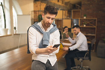 Image showing Man working in modern office using devices and gadgets during creative meeting.