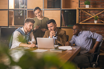 Image showing Colleagues working together in modern office using devices and gadgets during creative meeting