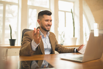 Image showing Man working in modern office using devices and gadgets during creative meeting.