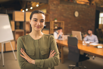 Image showing Woman working in modern office using devices and gadgets during creative meeting.