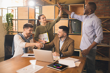 Image showing Colleagues working together in modern office using devices and gadgets during creative meeting