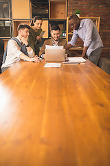 Image showing Colleagues working together in modern office using devices and gadgets during creative meeting