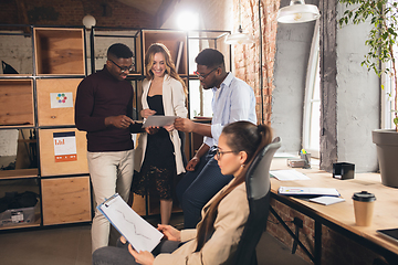 Image showing Colleagues working together in modern office using devices and gadgets during negotiations