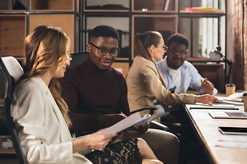 Image showing Colleagues working together in modern office using devices and gadgets during negotiations