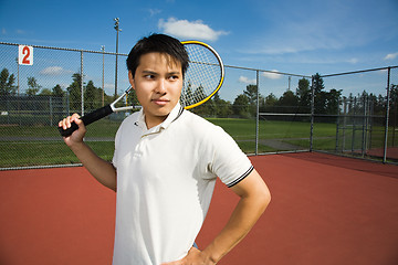 Image showing Asian man playing tennis