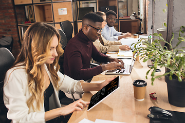 Image showing Colleagues working together in modern office using devices and gadgets during negotiations