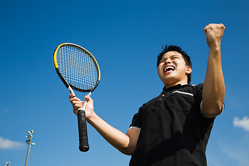Image showing Asian tennis player joy in victory