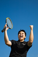 Image showing Asian tennis player joy of winning