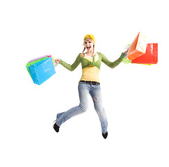 Image showing Happy caucasian girl jumping with shopping bags