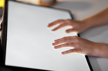 Image showing hands on led light tablet at night office