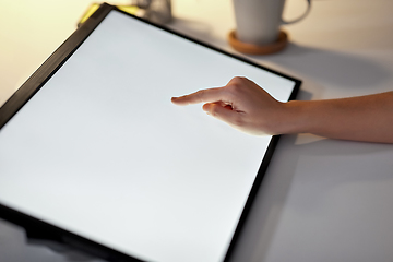 Image showing hand on led light tablet at night office