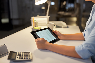 Image showing businesswoman with tablet computer at night office