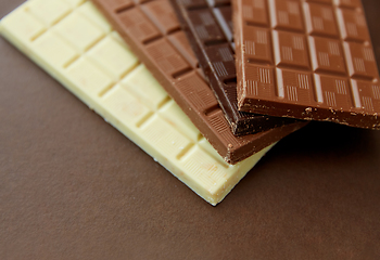 Image showing different kinds of chocolate on brown background