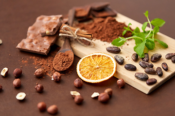 Image showing chocolate with hazelnuts, cocoa beans and orange