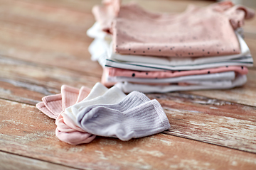 Image showing close up of baby clothes on wooden table