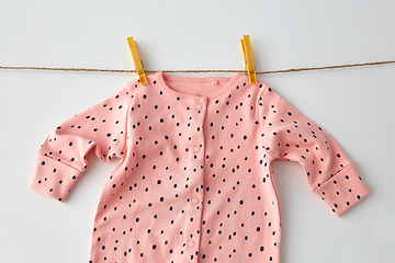 Image showing bodysuit for baby girl hanging on rope with pins