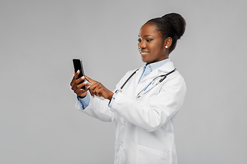 Image showing african american female doctor with smartphone