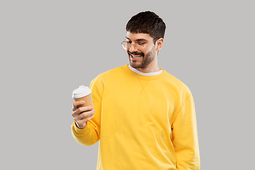 Image showing smiling young man with takeaway coffee cup