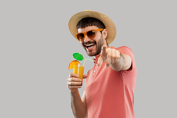 Image showing happy man in straw hat with orange juice cocktail