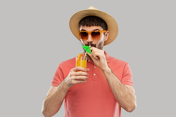 Image showing happy man in straw hat with orange juice cocktail