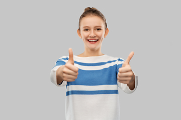 Image showing smiling teenage girl showing thumbs up