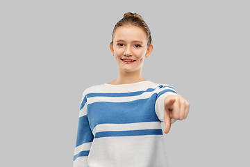 Image showing smiling teenage girl pointing to camera