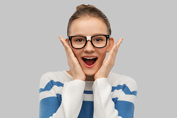 Image showing surprised teenage student girl in taped glasses