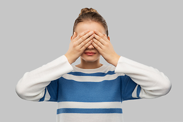 Image showing teenage girl closing eyes with hands
