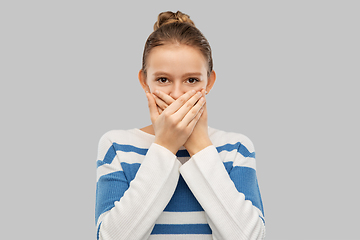 Image showing teenage girl covering mouth by hands