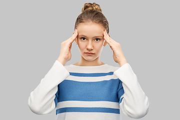 Image showing teenage girl having headache over grey background