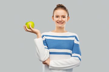 Image showing smiling teenage girl in pullover with green apple