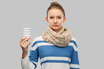 Image showing sick teenage girl in scarf with medicine pills