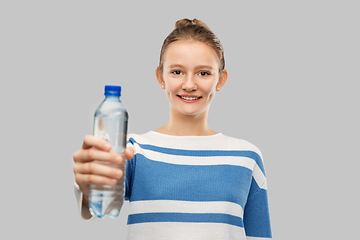 Image showing smiling teenage girl with bottle of water