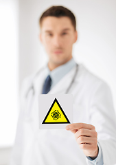 Image showing male doctor holding coronavirus caution sign