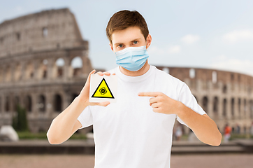 Image showing man in medical mask with coronavirus sign in italy