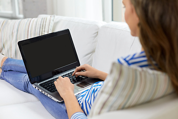 Image showing close up of teenage girl typing on laptop at home