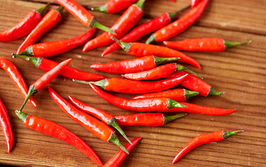 Image showing red chili or cayenne pepper on wooden boards