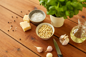 Image showing ingredients for basil pesto sauce on wooden table