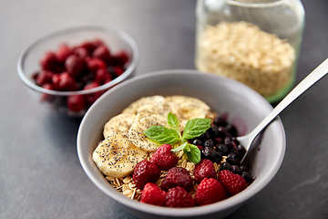 Image showing cereal breakfast with berries, banana and spoon