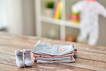 Image showing baby clothes on wooden table at home