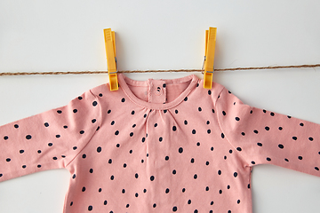 Image showing pink shirt for baby girl hanging on rope with pins