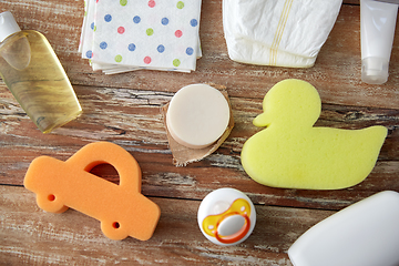 Image showing baby accessories for bathing on wooden table