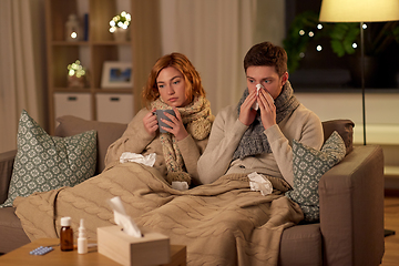 Image showing sick young couple drinking hot tea at home