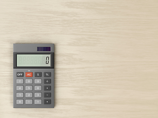 Image showing Calculator on wooden desk