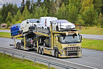 Image showing Gold Volvo FM Vehicle Carrier Hauls Cars