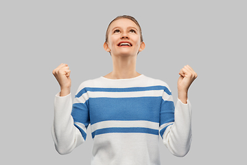 Image showing happy teenage girl in pullover celebrating success