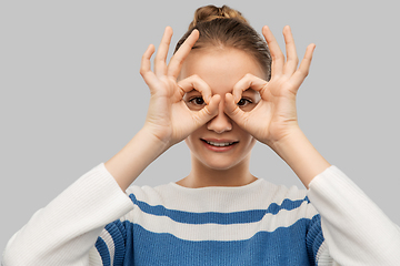 Image showing teenage girl looking through finger glasses