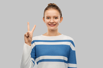 Image showing smiling teenage girl showing peace hand sign