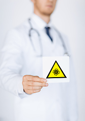 Image showing male doctor holding coronavirus caution sign