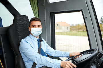 Image showing driver in medical mask driving intercity bus